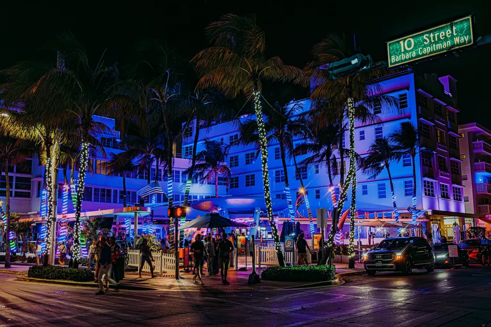 Busy art deco district street corner at night in Miami Beach