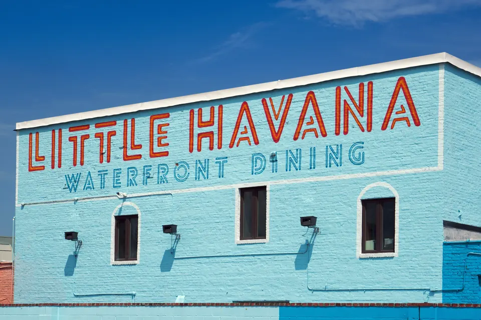 Little Havana waterfront dining sign on a light blue building