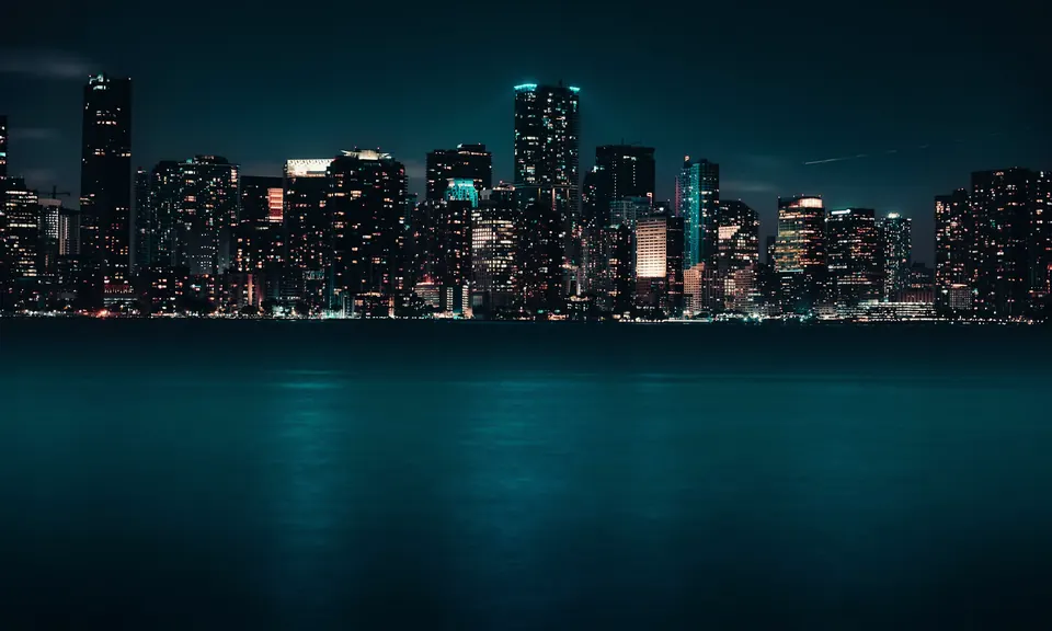 Miami skyline glowing across Biscayne Bay at night