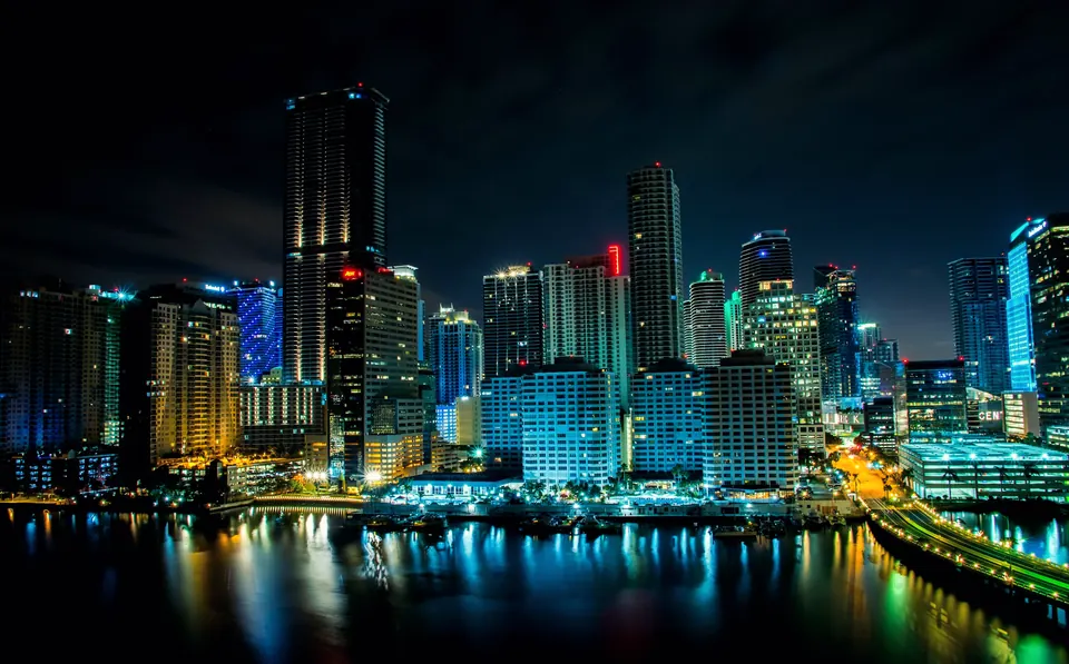 Brickell skyline lit up at night over the water, home to many of the Miami businesses we build websites for